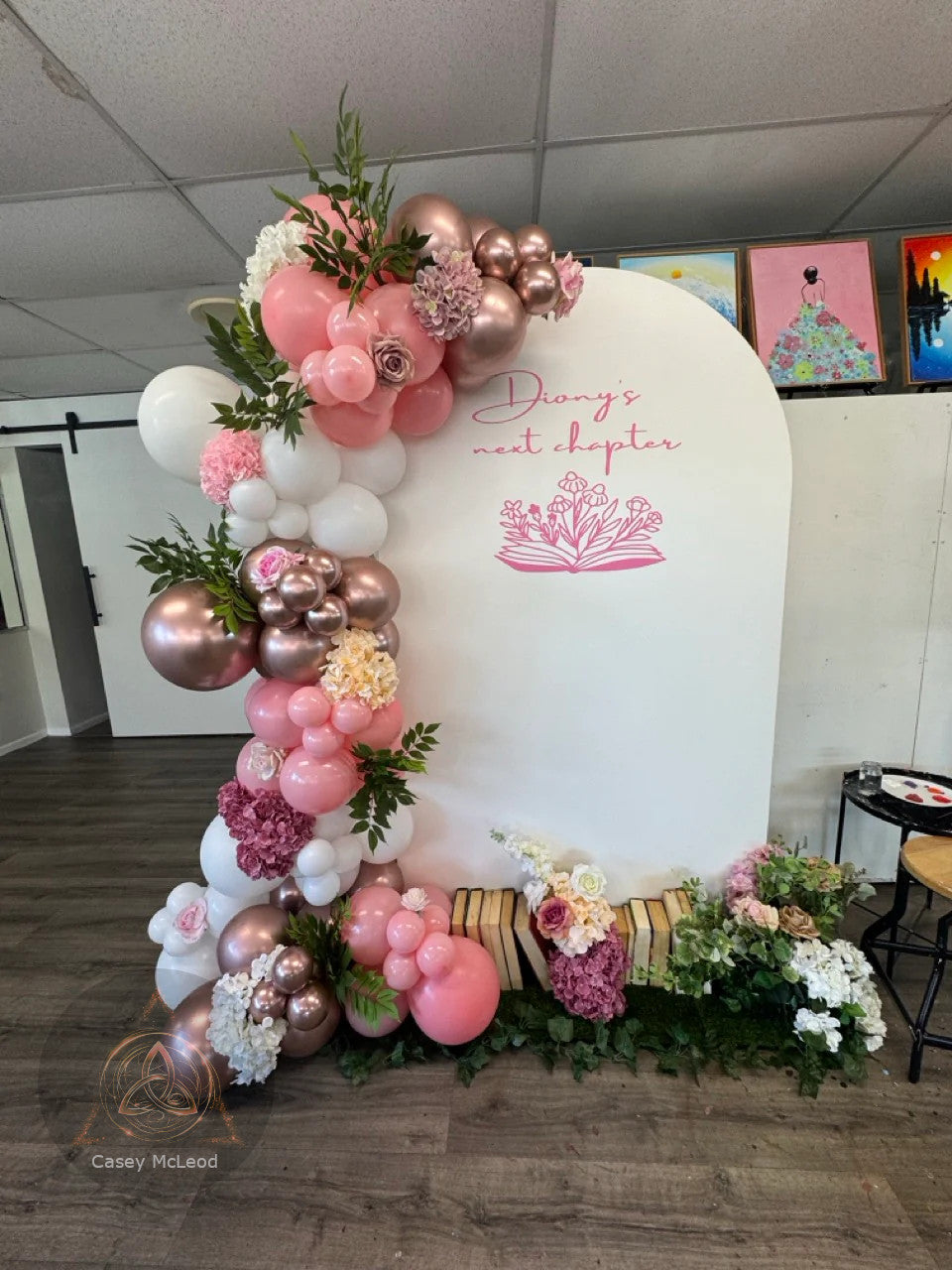 Decorative arch with balloons and flowers in a room setting